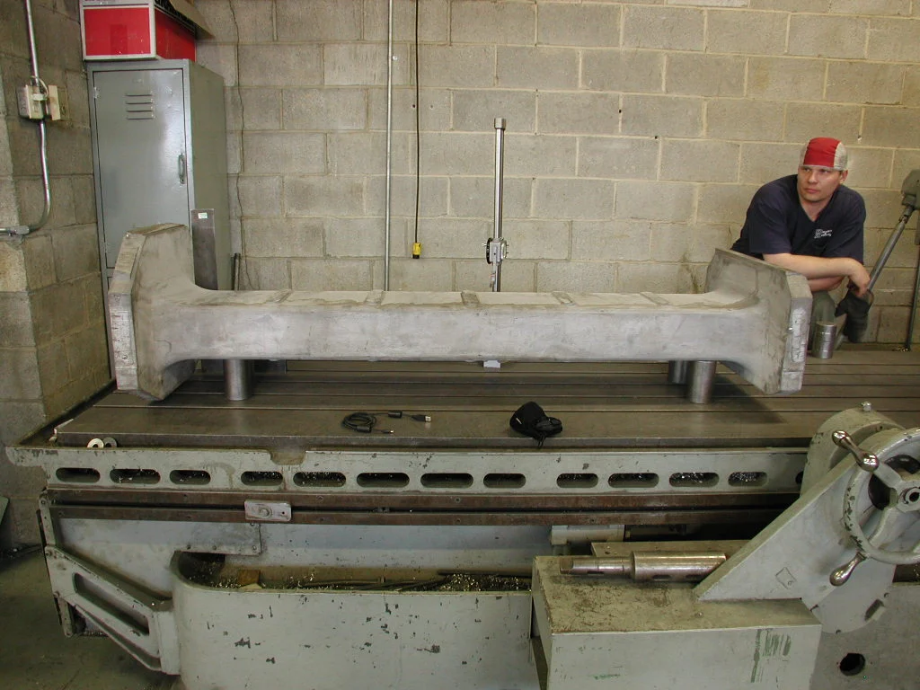 An employee beside in-house heat-treatment equipment