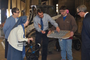 John Danko, President of Danko Arlington, center, shows the key molds to onlookers from the National Shrine of Elizabeth Ann Seton. From the left, Sister Dinah White, Sister Lawrence Marie Callaghan, Sebastian Arbona of Danko Arlington, and Ray Alcaraz, Director of Development and Stewardship.