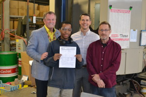 John Vontran, Program Manager of the Maryland Apprenticeship and Training program joins Danko Arlington President John Danko Machine Shop Superintendent Mike Allen with Jonathan Hite -- the company's newest apprentice. 